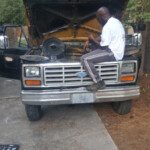 Mr. Green Thumb Sitting in Engine of Truck