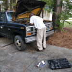 Mr. Green Thumb Looking In Hood of the Truck